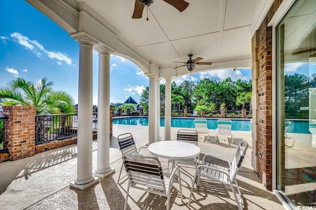 view of patio / terrace with ceiling fan and a community pool