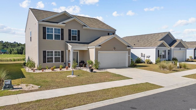 view of front of property featuring a front yard and a garage