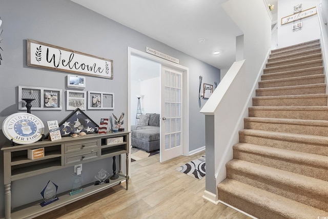 stairway with hardwood / wood-style floors