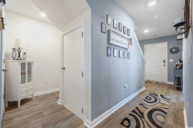 corridor with light hardwood / wood-style floors