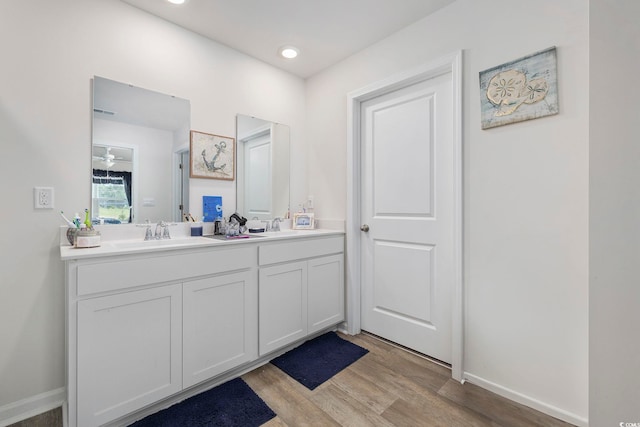 bathroom featuring hardwood / wood-style flooring, vanity, and ceiling fan