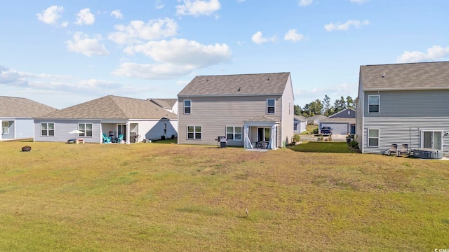 back of house with a lawn