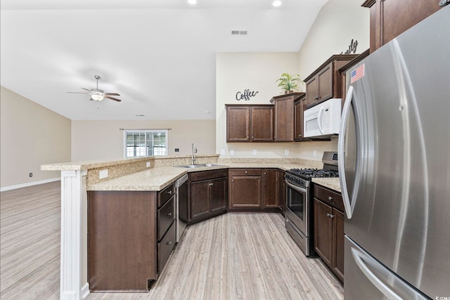 kitchen with sink, light hardwood / wood-style flooring, ceiling fan, appliances with stainless steel finishes, and kitchen peninsula