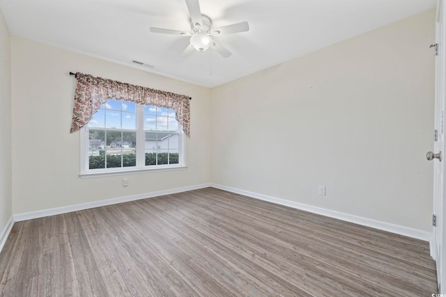 empty room featuring ceiling fan and wood-type flooring