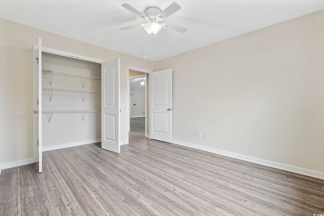 unfurnished bedroom with ceiling fan, light hardwood / wood-style flooring, and a closet