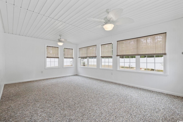 unfurnished sunroom featuring ceiling fan