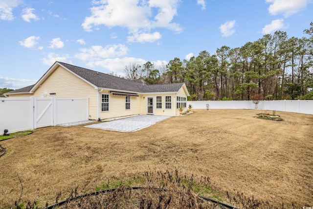 rear view of property with a lawn and a patio area