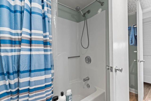 bathroom featuring hardwood / wood-style floors and shower / bath combo