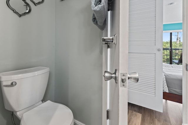 bathroom with hardwood / wood-style floors and toilet