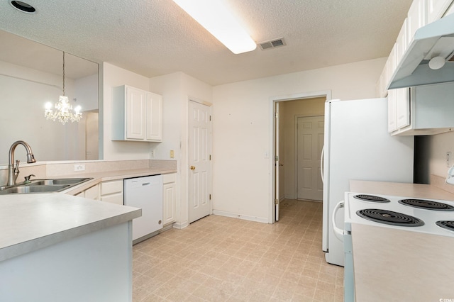 kitchen featuring white cabinetry, sink, a chandelier, pendant lighting, and white appliances