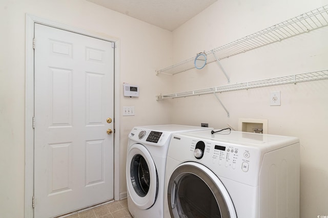 clothes washing area featuring washer and dryer and a textured ceiling