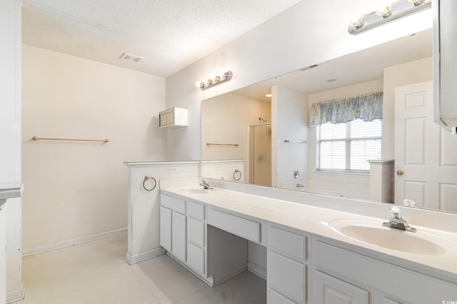 bathroom with vanity, shower with separate bathtub, and a textured ceiling