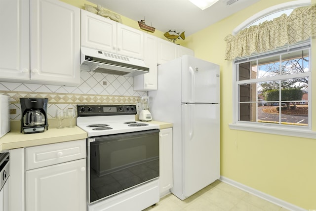 kitchen with tasteful backsplash, white cabinetry, and white appliances