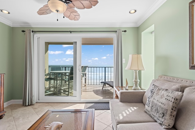 tiled living room featuring ceiling fan, a water view, and crown molding