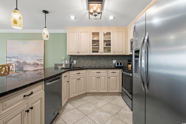 kitchen with dark stone counters, crown molding, sink, hanging light fixtures, and stainless steel appliances