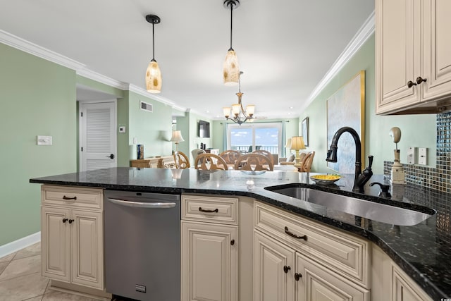 kitchen with dark stone countertops, dishwasher, sink, and a chandelier