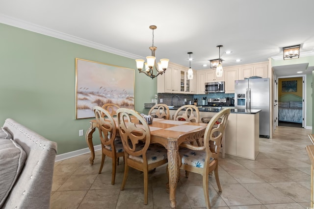 dining room with sink, light tile patterned floors, a chandelier, and ornamental molding