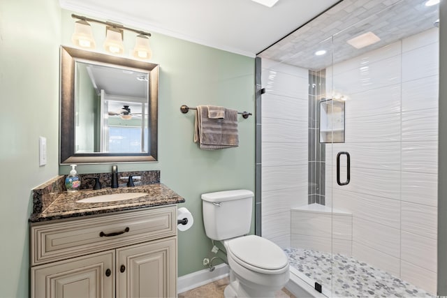 bathroom featuring vanity, toilet, walk in shower, and crown molding