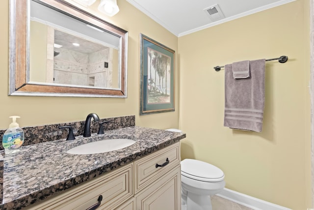 bathroom with vanity, toilet, and ornamental molding