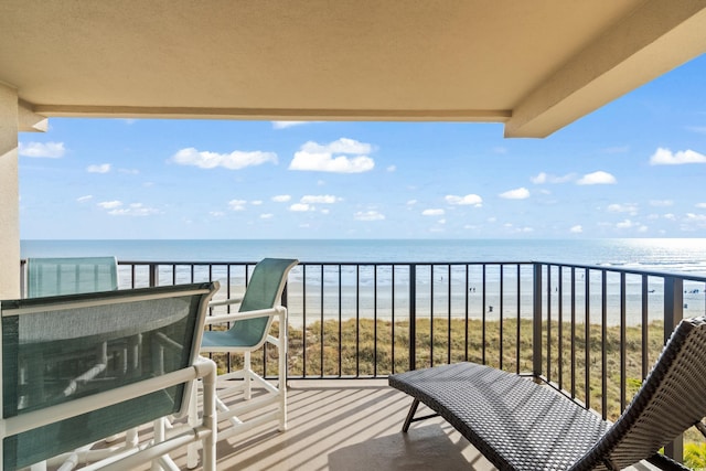 balcony with a beach view and a water view