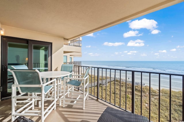 balcony with a view of the beach and a water view