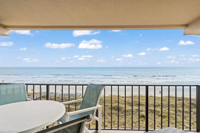 balcony with a view of the beach and a water view