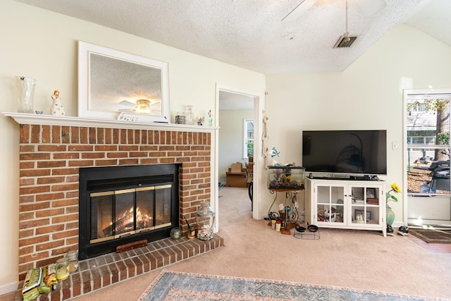 carpeted living room featuring a textured ceiling, a brick fireplace, ceiling fan, and lofted ceiling