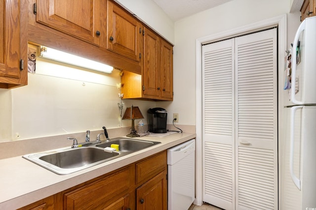 kitchen with white appliances and sink