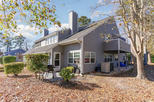 back of property with a patio area and central air condition unit