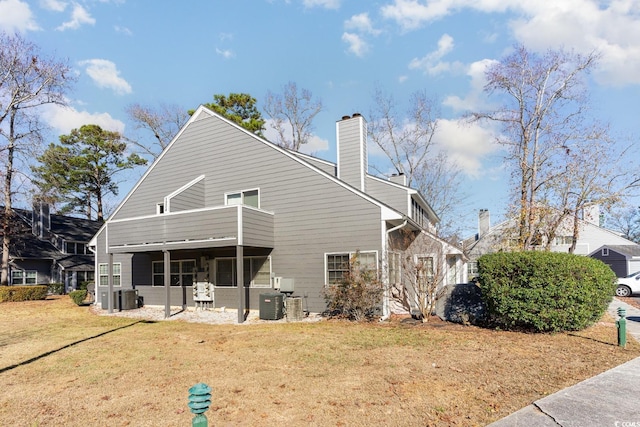 exterior space with a balcony, cooling unit, and a front yard