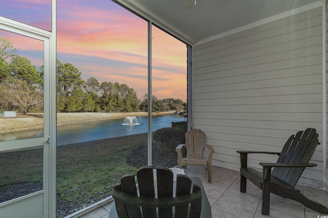 sunroom / solarium featuring a water view