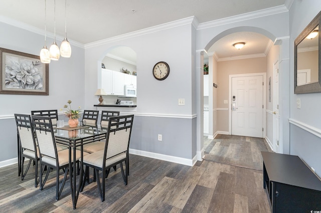 dining space featuring dark hardwood / wood-style floors and ornamental molding