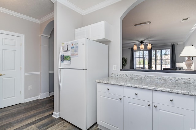 kitchen featuring white cabinets, ornamental molding, a textured ceiling, white fridge, and dark hardwood / wood-style flooring