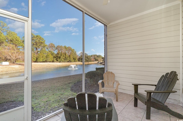 sunroom / solarium featuring a water view and plenty of natural light