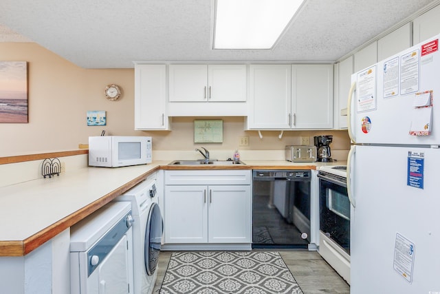 kitchen with a textured ceiling, white appliances, sink, white cabinets, and washer / clothes dryer