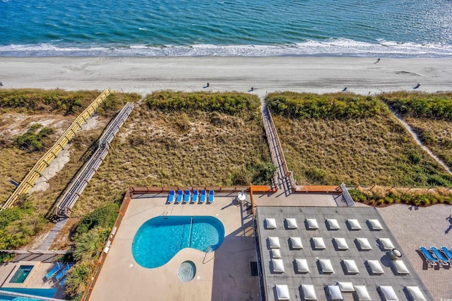 birds eye view of property featuring a view of the beach and a water view