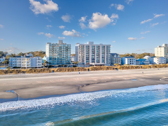 exterior space featuring a water view and a view of the beach