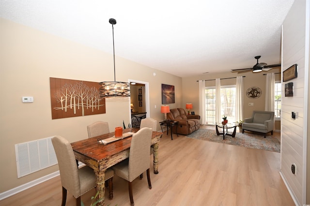 dining space featuring light wood-type flooring and ceiling fan