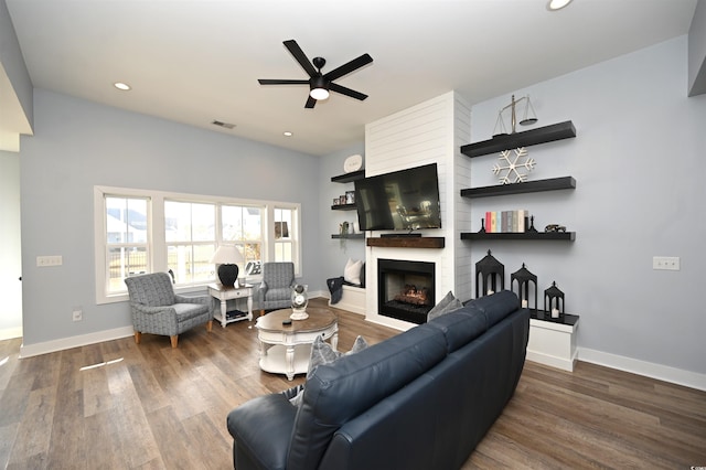 living area featuring wood finished floors, a fireplace, recessed lighting, and ceiling fan