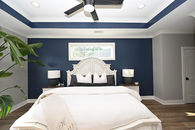 bedroom featuring a tray ceiling, ceiling fan, crown molding, and dark hardwood / wood-style floors