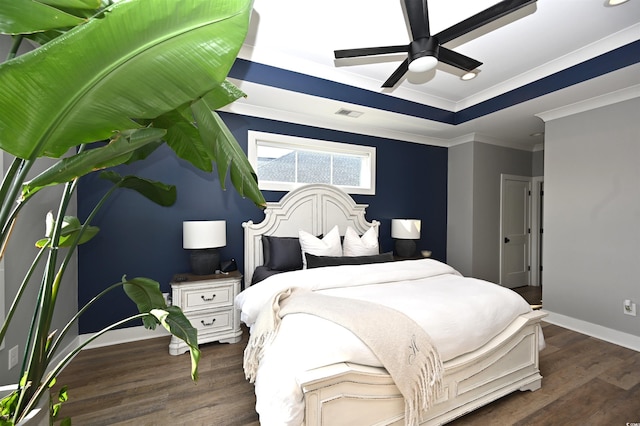 bedroom with dark wood-style floors, visible vents, baseboards, a ceiling fan, and ornamental molding
