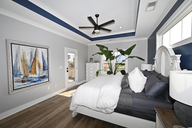 bedroom featuring access to exterior, ceiling fan, dark wood-type flooring, crown molding, and a tray ceiling