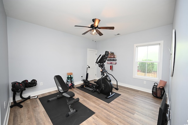 workout area featuring wood finished floors, visible vents, baseboards, and ceiling fan