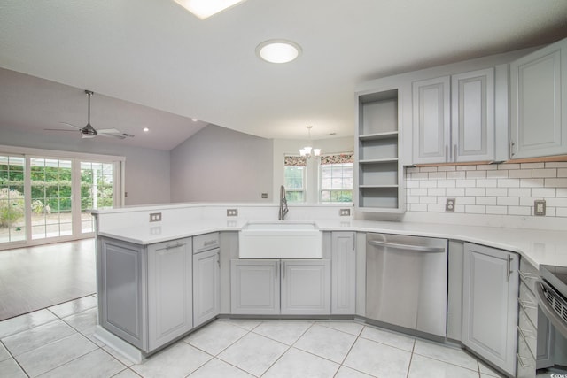 kitchen with pendant lighting, dishwasher, gray cabinetry, ceiling fan with notable chandelier, and sink