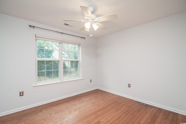 unfurnished room featuring ceiling fan, a textured ceiling, and light wood-type flooring