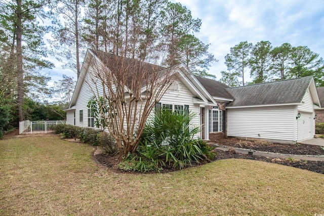 view of front of property with a front yard and a garage