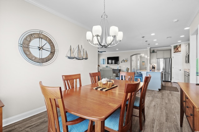 6550 Anterselva Dr, Myrtle Beach, SC 29572 - dining room featuring a chandelier, wood finished floors, recessed lighting, ornamental molding, and arched walkways