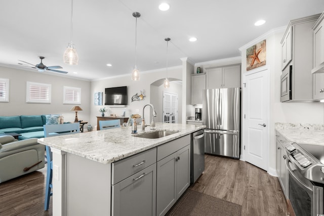 6550 Anterselva Dr, Myrtle Beach, SC 29572 - kitchen with stainless steel appliances, a sink, gray cabinetry, arched walkways, and open floor plan