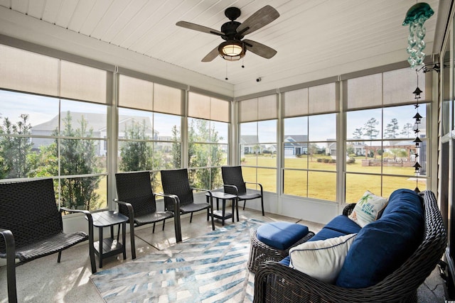 sunroom / solarium featuring plenty of natural light, ceiling fan, and an outdoor living space