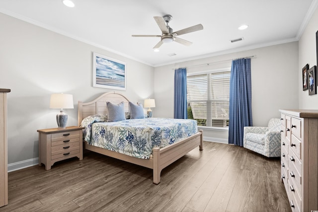 bedroom featuring baseboards, visible vents, and wood finished floors